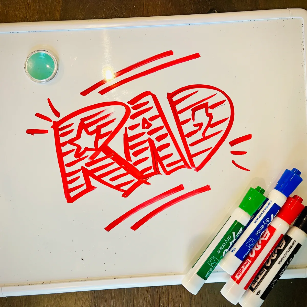 An image of a whiteboard with RAD written in red marker
