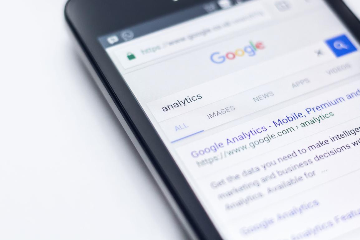Smartphone showing a search for "Analytics" on Google