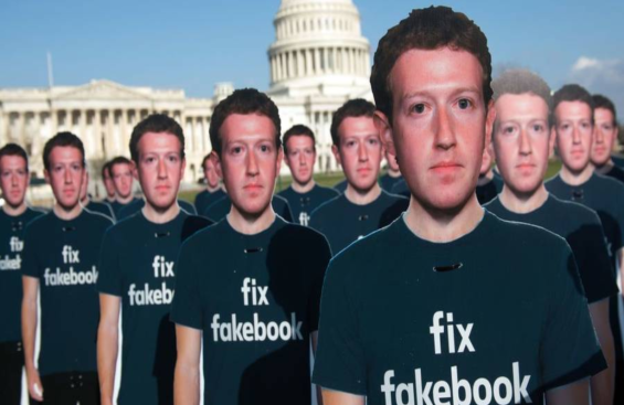 100 cardboard cutouts of FB founder/CEO Zuckerberg outside the US Capitol in DC on 4/10/2018. Avaaz is calling attention to what the groups says are hundreds of millions of fake accounts still spreading disinformation on FB. -SAUL LOEB/AFP/Getty Images